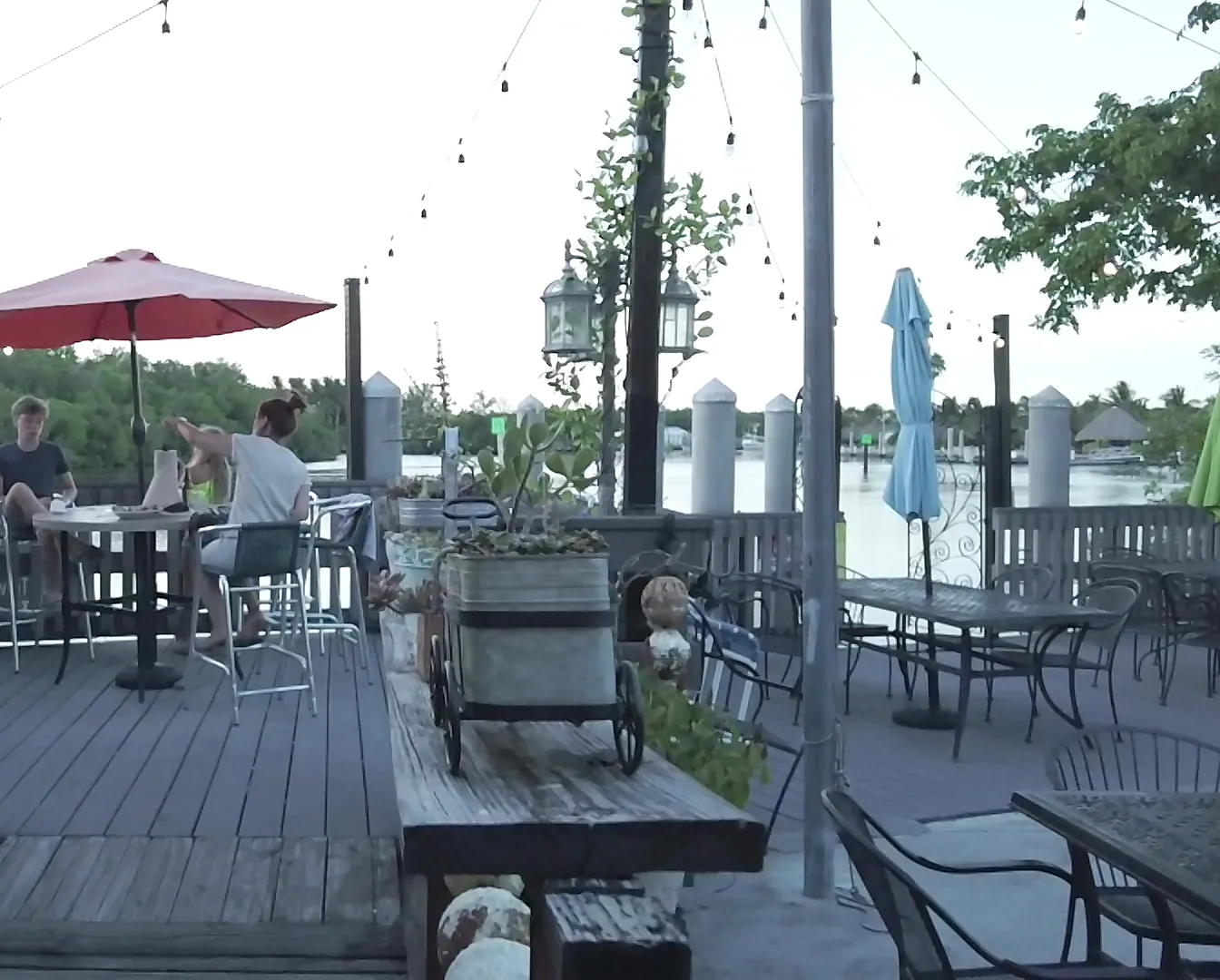 The waterfront deck with umbrellas and string lights