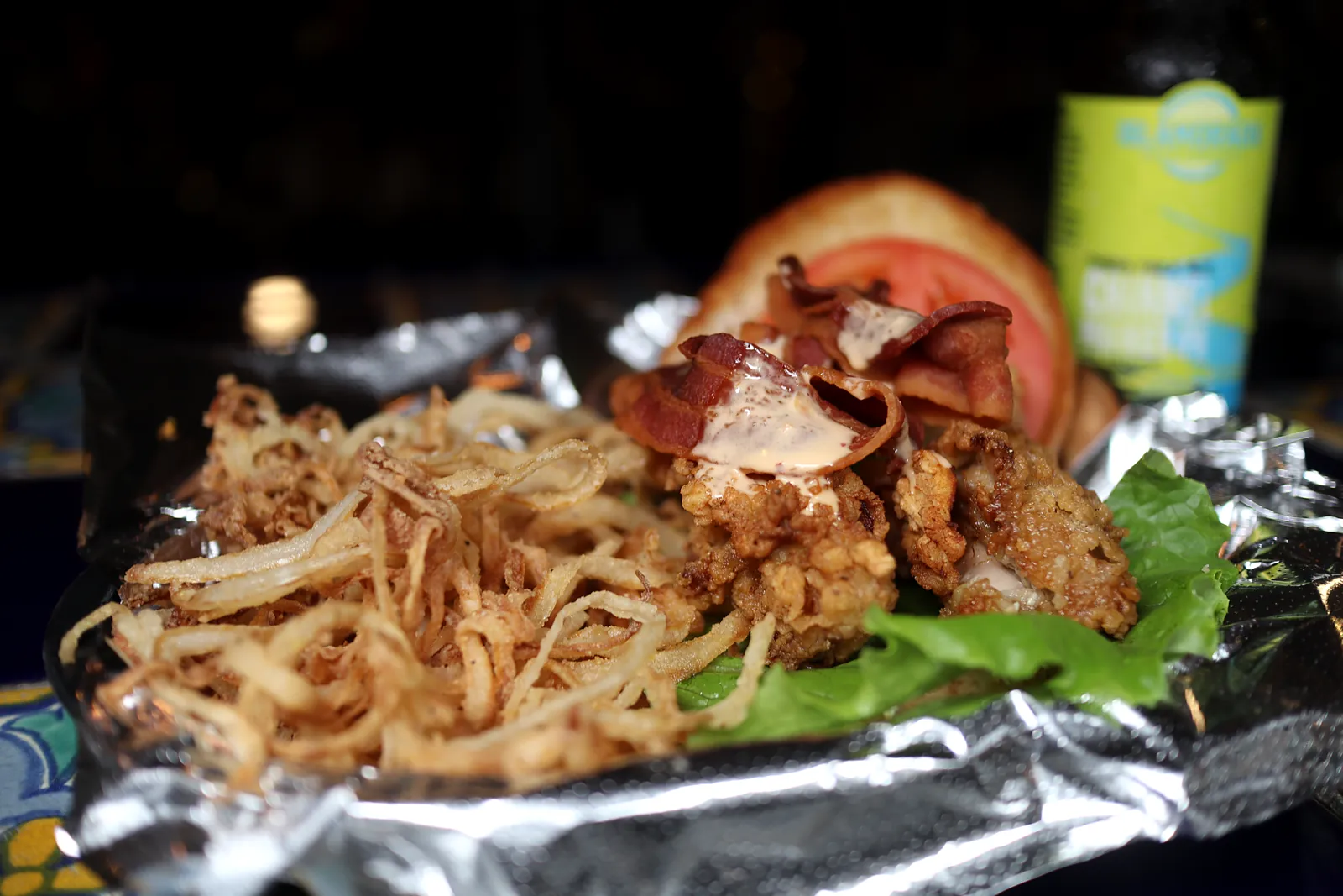 Sandwich with a pile of onion straws