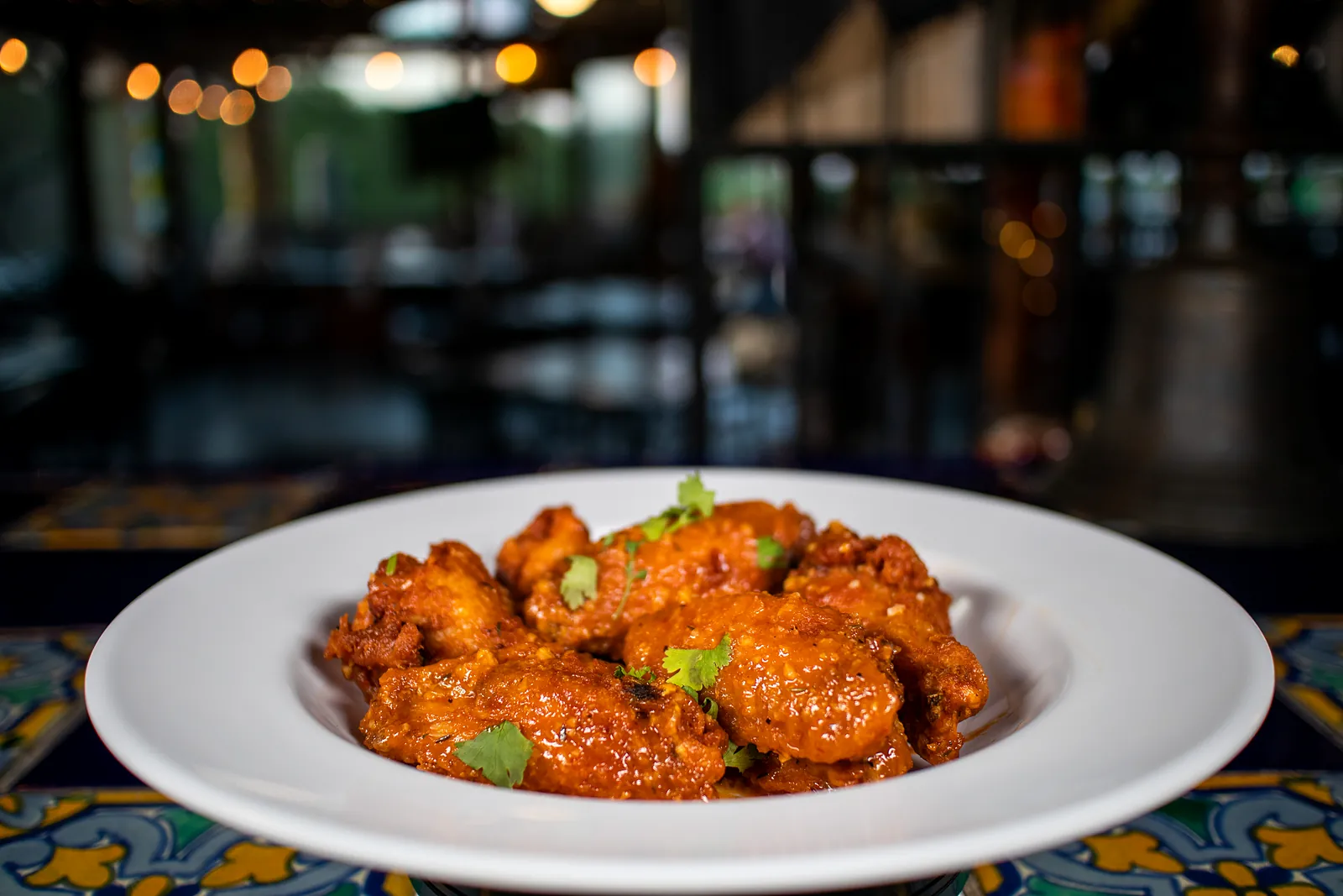 Shrimp in a red sauce on a tile table